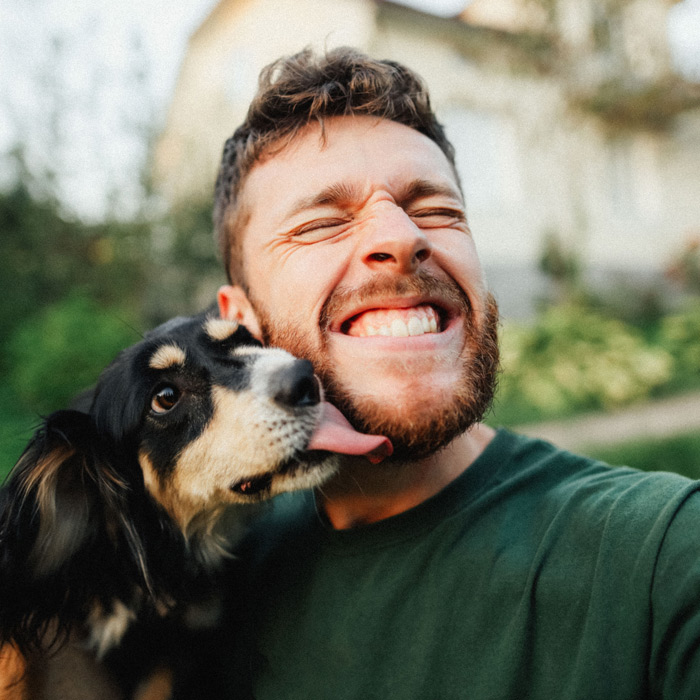 Young man playing with a dog