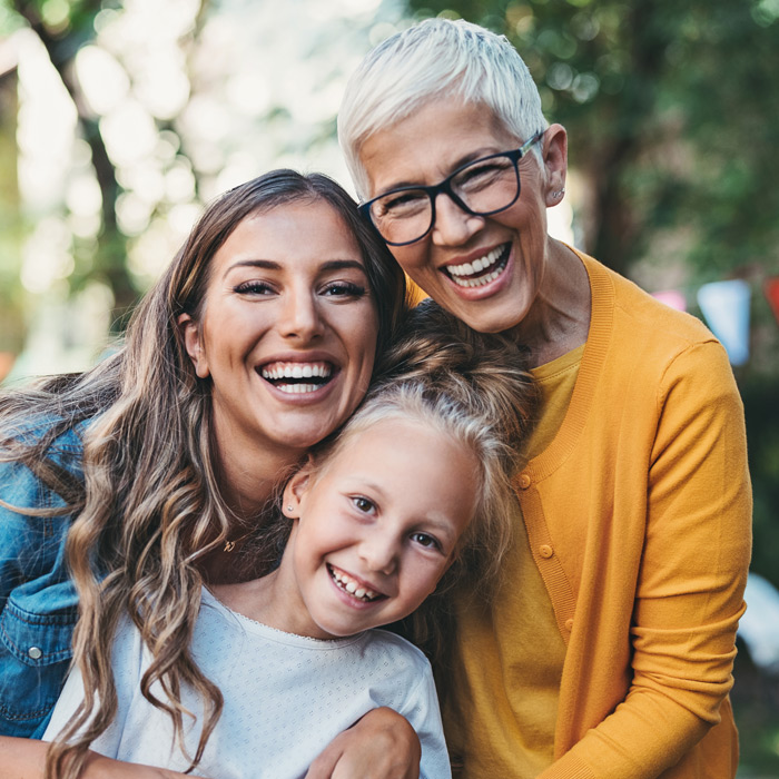 Three generations of women smiling
