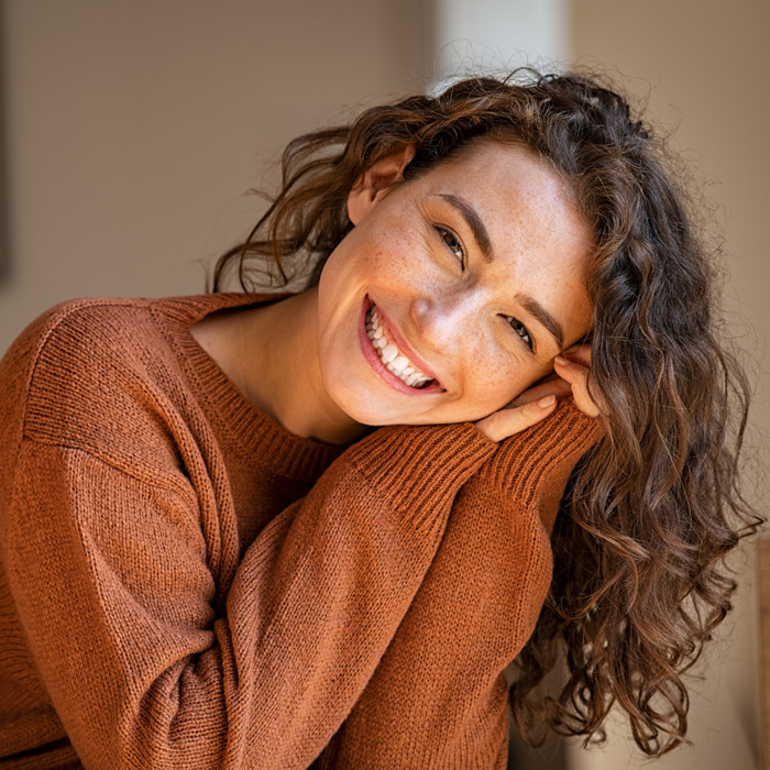 Young woman laughing while relaxing at home