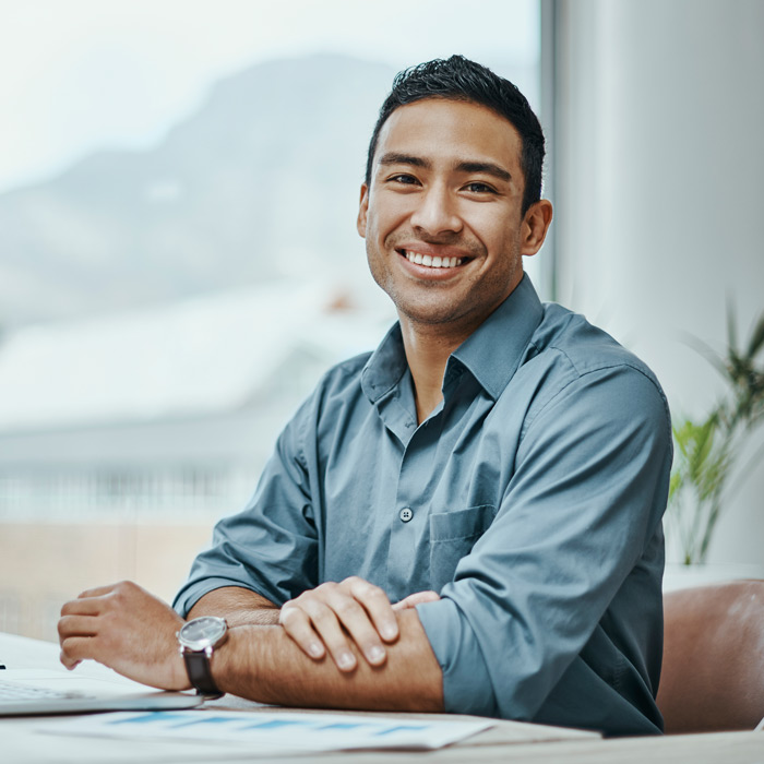 Shot of a young businessman using a laptop in a modern office