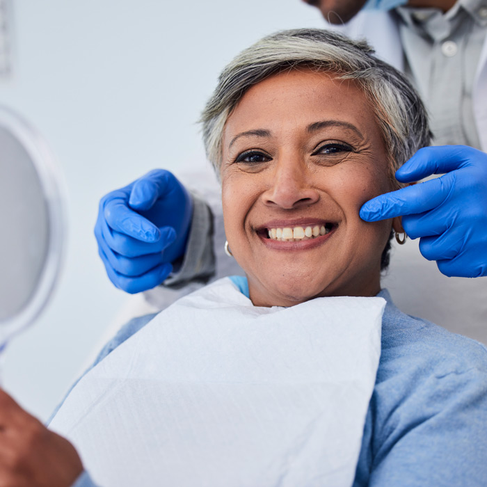 Happy senior woman at dentist